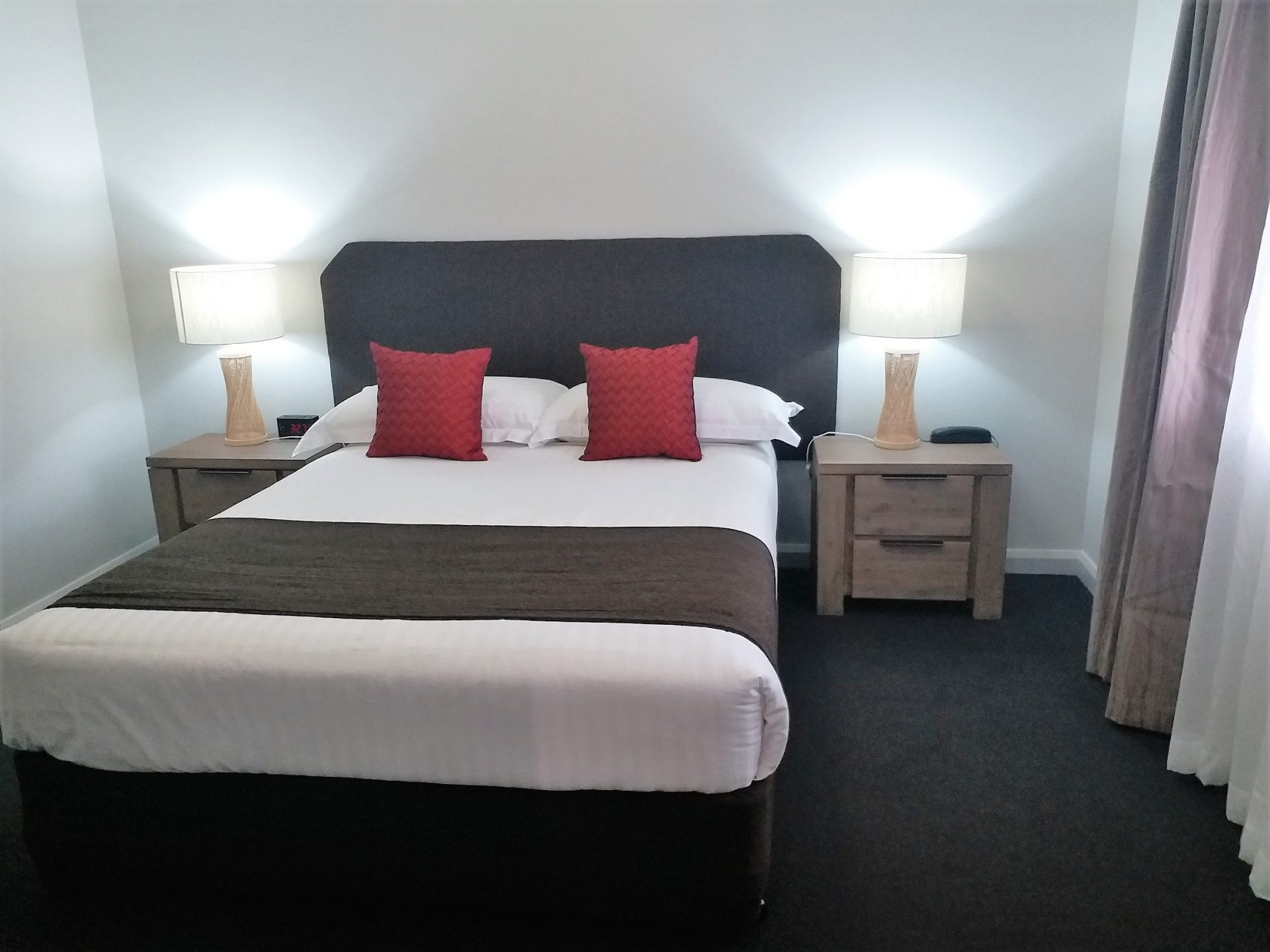 Bed and side tables with lamps